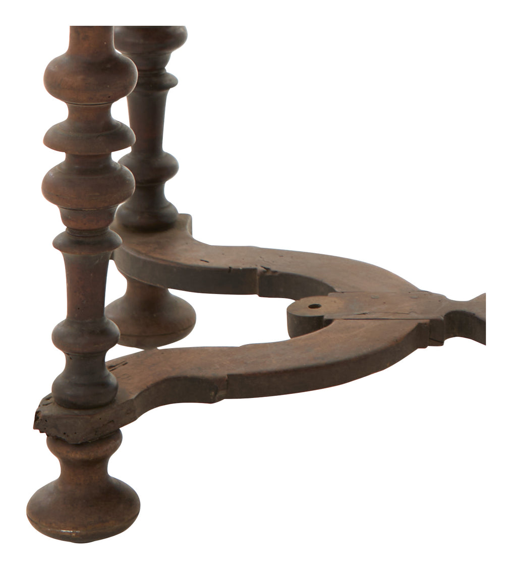 Close-up of a wooden table's legs with intricate design on a white background