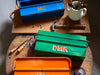 brightly colored toolboxes on wooden tables