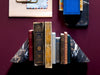 vintage books between two marble bookends